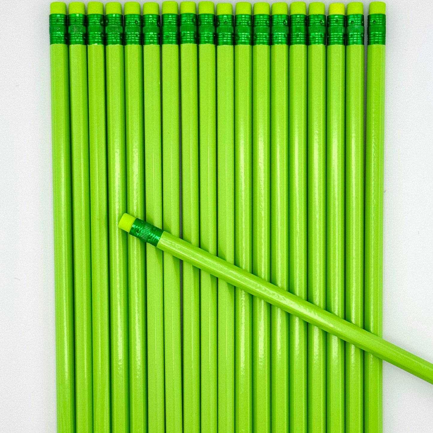 Green pencils with erasers on a white background