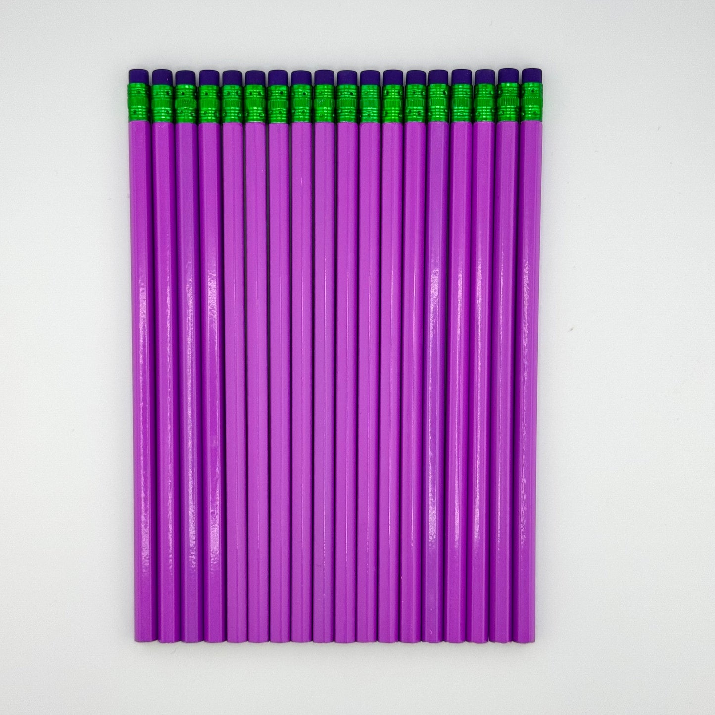 Purple pencils with purple erasers arranged in a grid on a white background